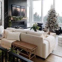 a living room filled with furniture and a christmas tree