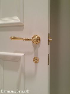 an open door with a golden handle on it