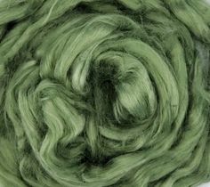 a green ball of yarn on a white surface