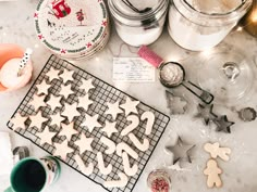 some cookies are laying out on a cookie sheet and baking utensils next to them