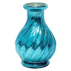 a blue glass vase sitting on top of a table