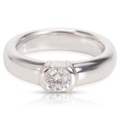 a white gold ring with a round diamond