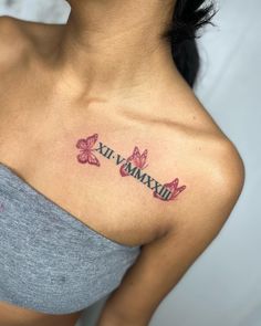 a woman's chest with butterflies and the word maximum tattooed on her left shoulder