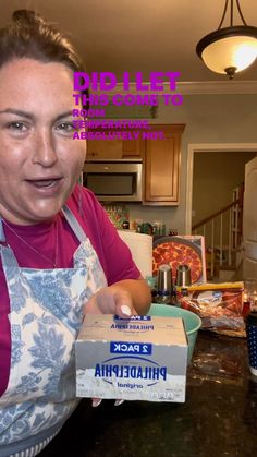 a woman in an apron is holding a pizza box with the word philadelphia on it