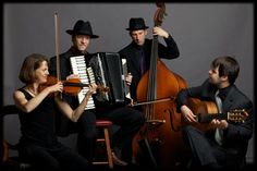 three people are playing instruments and posing for the camera