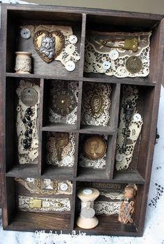 an old wooden box filled with lots of different items on top of a white table