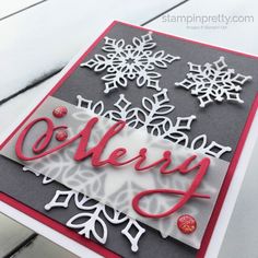 a handmade christmas card with snowflakes and the word merry written on it