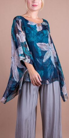 100% Silk Kaftan Style Blouse with a Floral Lily Print. Features 3/4 Length Sleeves and a Wavy Bottom. Exterior: 100% Silk Interior: 95% Viscose, 5% Elastic Fits Sizes XS- XL Made in Italy Elegant Rayon Beach Tops, Flowy Floral Print Tunic Top, Printed Flowy Tunic Blouse, Flowy Printed Tunic Blouse, Floral Print Half Sleeve Blouse For Beach, Beach Blouse With Floral Print And 3/4 Sleeves, Beach Blouse With 3/4 Sleeves And Floral Print, Floral Print Beach Blouse With 3/4 Sleeves, Half Sleeve Blouse With Floral Print For Beach