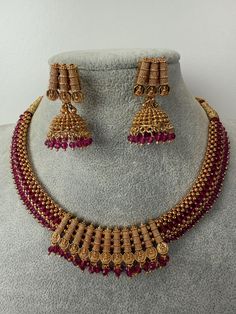 This exquisite piece of craftsmanship comes from our Traditional collection. Finish: 24 grams gold finish Necklace Fastening: Adjustable Dori  Perfect for Indian weddings. Earring jhumka Fastening: Push Back Contains: 1 necklace, 1 pair of earrings Gold Chandbali Necklace With Latkans, Heavy Gold Necklace For Celebration, Gold Chandbali Necklaces For Celebration, Gold Necklaces With Latkans For Wedding, Gold Necklaces With Latkans For Festive Occasions, Gold Latkans Necklace For Wedding, Gold Chandbali Necklace For Celebration, Gold Necklace With Latkans For Wedding, Heavy Gold Necklaces For Festive Occasions