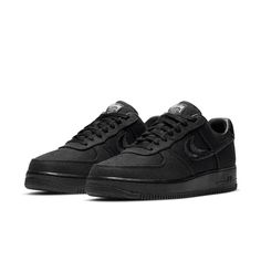 The Nike Stussy x Air Force 1 Low 'Triple Black' is a sleek and stylish sneaker that's perfect for everyday wear. With its breathable hemp construction, this sneaker is comfortable and easy to wear, while the split-embroidered Swoosh and Stussy's double S logo add a touch of style. The interlocking letters on the heel tab and tongue tag are also a nice touch, while the World Tour iconography on the tongue tag is a nice finishing touch. Nike High-top Sneakers With Textured Sole For Streetwear, Nike Sporty Custom Sneakers With Textured Sole, Nike Custom Sneakers With Textured Sole, Nike Custom Sneakers With Textured Sole In Sporty Style, Nike Custom Sneakers With Textured Sole, Sporty Style, Nike Athleisure Custom Sneakers, Nike Urban Synthetic Sneakers, Nike Urban Sneakers In Synthetic Material, Modern Cushioned Sneakers For Streetwear