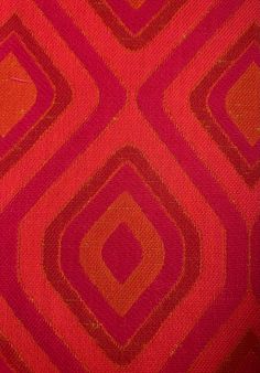 an orange and red pattern on fabric