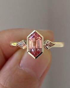 4.00 CT Peach Pink Hexagon Cut Moissanite Engagement Ring/ 14K Solid Gold Three Stone Ring/ Promise Bezel Ring For Her/ Proposal Bridal Ring Ring | Engagement Ring | Art Deco Ring | Vintage Ring | 925 Silver Ring | Moissanite Ring | Diamond Ring | Anniversary Ring | Wedding Band | Art Deco | White Gold Ring | Promise Ring | Estate Ring | Hexagon Cut | Hexagon Cut Diamond Ring | Hexagon Cut Engagement Rings | Hexagon Cut Ring | Hexagon Diamond | Hexagon Diamonds For Sale | Hexagon Cut Moissanite | Hexagon Cut Moissanite Ring | Hexagon Ring | Hexagon Cut Diamond Ring ✥ 𝐌𝐚𝐢𝐧 𝐒𝐭𝐨𝐧𝐞 𝐃𝐞𝐭𝐚𝐢𝐥𝐬 ↬ Shape: Hexagon Cut ↬ Type: Moissanite ↬ Weight: 4.00 CT (App.) ↬ Dimension: 11*7 MM(App.) ↬ Color: Peach Pink ↬ Clarity: VVS-VS ↬ Making Process: Handmade - Crafted by our experienced team Pink Moissanite Engagement Ring, Pink Moissanite Ring, Bezel Set Engagement Ring, Hexagon Diamond, Bezel Set Ring, Pink Sapphire Ring, Diamond Anniversary Rings, Pink Stone, Moissanite Ring