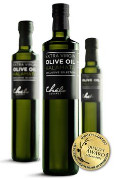 three bottles of extra virgin olive oil with a gold medal around the neck and bottom