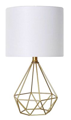 a gold metal table lamp with a white shade on the base and a white fabric lampshade