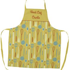 a yellow apron with blue and red kitchen utensils on it that says head chef charlotte