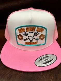 Red Dirt Hat Co. white and pink flat bill style snapback featuring the exclusive Buffalo Skull patch. Red Dirt Hat Co. is a brand for everyone. White Front Pink Mesh Back 5 Panel Red Dirt Buffalo Skull Patch Adjustable Snapback Flat Bill Buffalo Skull, Skull Patch, Flat Bill Hats, Snap Back Hat, Western Store, Red Dirt, Pink Flats, Western Hats, Cowgirl Western