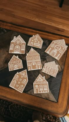 wooden cutout houses sitting on top of a table