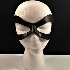 DESCRIPTIONAdd spice to your love life! This small, very lightweight, black leather mask is perfect for the beginner dominatrix or Lord of the Bedroom. Any color. Silver studs available. Waterproofed leather, glossy or matte finish, & several choices to affix the mask (cord, elastic, ribbon, waterproof cord, stick, or no holes for adhesive). Measurements: 3" high x 7" wide (tallest & widest points); 1" high between the eyes; 2.75" wide x 2.75" tall eye openings ---------------------------------- Lone Ranger Costume, Splatoon Costume, Robin Superhero, Comicon Costume, Wedding Masquerade, Ranger Costume, New Years Eve Ball, Masquerade Prom, Robin Cosplay