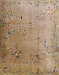 an old rug with flowers and vines on the bottom is shown in light brown tones