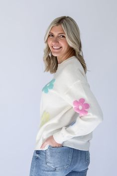 Are you ready to brighten everyone's day with our Flower Power Daisy Print Sweater!? This white knit sweater has the most adorable pastel daisy print that is perfect to help you transition from Winter to Spring. This sweater is perfectly light weight and detailed with a ribbed contrast hem around the round neckline and arm cuffs. Pair it with jeans on a chilly day, or with shorts for the perfect Spring look! - White knit sweater with pastel daisy print - Light weight knit sweater - Ribbed contra Cute Crew Neck Sweater For Spring, White Playful Knit Top, Playful White Knit Top, White Knit Playful Tops, Trendy Floral Print Sweater For Spring, Spring Cream Knit Sweater, Cream Knit Sweater For Spring, White Soft Knit Sweater For Spring, Trendy Cream Sweater For Spring