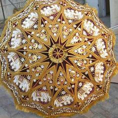 an ornately decorated umbrella is on display