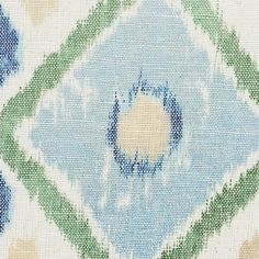 a blue, green and white fabric with an abstract design on it's side