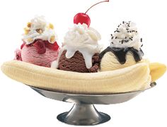 three scoops of ice cream in a banana split on top of a metal dish