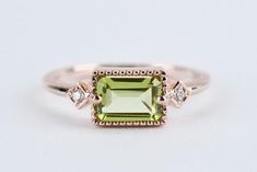 Elegant Rectangular Diamond Ring With Accent Stones, Rectangular Green Diamond Ring For Anniversary, Green Rectangular Diamond Ring For Anniversary, Classic Green Rectangular Diamond Ring, Formal Green Rectangular Diamond Ring, Green Rectangular Diamond Ring For Gift, Green Rectangular Diamond Ring Gift, Green Rectangular Rings With Bezel Setting, Green Rectangular Bezel Set Ring