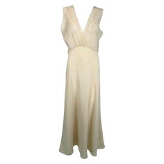 1930s cream bias cut sheer silk hand embroidered & appliqued slip dress gown. Beautiful sheer silk gown in pale cream. The cross over bodice has inset sheer silk panels at the bust, each with delicate applique & embroidery. The gown has a high waist, the bias skirt is fitted through the hips & flairs at the hem. Fits like a size medium. In excellent wearable condition. All our clothing is dry cleaned and inspected for condition and is ready to wear. Any condition issues will be noted. For visual Lace Tunic Dress, Bias Skirt, Color Crema, Maxi Gown Dress, Costume Institute, Silk Gown, Applique Embroidery, Dress Gown, Silk Chiffon