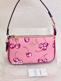 Coach Nolita 19 With Cherry Print Brand new with tags 100% Authentic COME WITH ORIGINAL PACKAGING Color: Flower Pink Product Details Printed coated canvas and smooth leather Two credit card slots Inside multifunction pocket Zip-top closure, fabric lining Chain handle with 6 1/4" drop 7 1/2" (L) x 4 1/2" (H) x 2" (W) Style No. CR827 Price is firm Same day shipping Coach Teri Shoulder Bag, Nolita 19, Girly Bags, Coach Shoulder Bag, Bags Aesthetic, Cherry Print, Pretty Bags, Cute Bags, Printed Bags