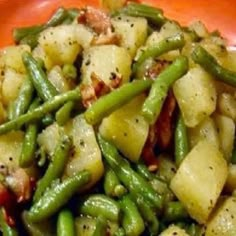 a close up of a plate of food with potatoes and green beans