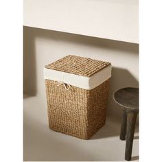 a basket sitting on the floor next to a stool