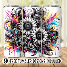 three white tumblers with colorful designs on them sitting on a wooden table in front of a window