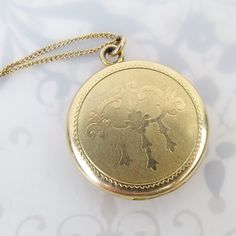 "R&G Co. (est. 1915, Attleboro, MA) made this round vintage gold filled \"LaMode\" brand engraved locket. The front has a subtle smooth chandelier style image with a stippled matte finish. The back has a spiral turned design. The locket opens with a small fingernail groove near the top and closes securely with a snap. Inside you will find both original rose gold hue frames and inserts.  One side is signed, \"LaMode\" (line attributed to R&G Co circa 1934). It is also marked \"1/20\" (gold filled Gold Medallion Locket Necklace Stamped 14k, Antique Medallion Locket Necklace Stamped 14k, Victorian Filigree Locket Necklace In Yellow Gold, Victorian Yellow Gold Locket Necklace With Filigree, Victorian Filigree Yellow Gold Locket Necklace, Victorian Round Locket Necklace Stamped 14k, Victorian Filigree Round Locket Necklace, Victorian Round Filigree Locket Necklace, Vintage Stamped 14k Locket Necklace For Wedding