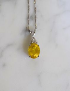 Metal: 14kt White Gold Stone: Yellow Sapphire And Diamond Stone Shapes: Round And Oval-Shape Yellow Sapphire Weight: 3.27 ctw, 9.84 x 7.82 mm Diamond Weight: .08 ctw, round diamonds Measurements Of Pendant From Bail To Bottom Of Pendant: 19.93 mm Weight of entire piece with chain: 2.50 grams Type of Chain: 1.2mm Diamond-cut Singapore Chain Length of Chain: 16 Inches Type of Lock: Spring Ring Note: Other chain styles and lengths available. Pendant can also be sold without chain. Please inquire if Stone Shapes, Pixie Hollow, Yellow Necklace, Sapphire Pendant, Women Necklace, Sapphire Necklace, Pretty Jewelry, Gold Stone, Fantasy Jewelry