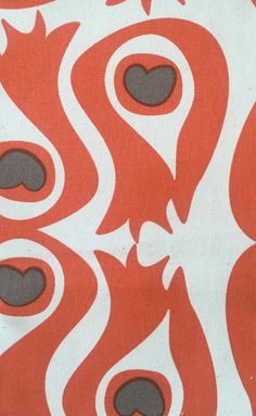 an orange and white fabric with black circles on it