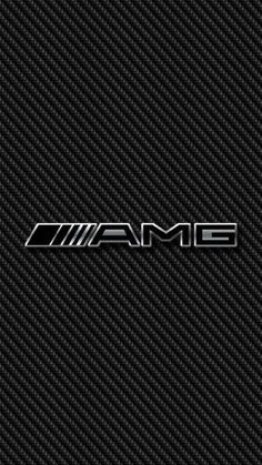 the word'amg'written in silver on a black carbon fiber textured background