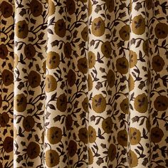 a curtain with brown and tan flowers on it