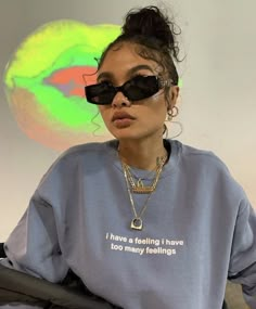 a woman wearing sunglasses and a sweatshirt that says i have a feeling i have too many feelings