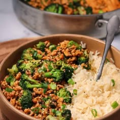 a bowl filled with rice and broccoli next to another bowl full of food