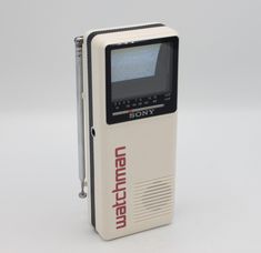 an old fashioned portable radio sitting on top of a white table next to a pen