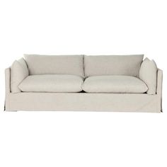 a white couch with two pillows on the back and one arm folded out to show it's fabric