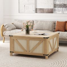 a living room with a couch, coffee table and pictures on the wall