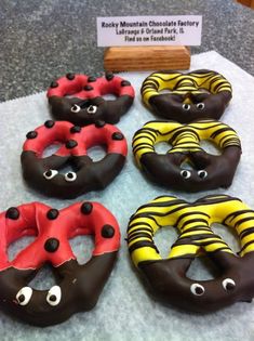 four donuts with chocolate icing and eyes on them