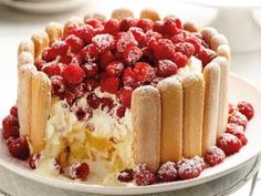 a cake with raspberries is on a plate