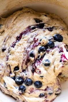 a bowl filled with batter and blueberries