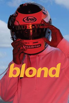 a man wearing a helmet and holding his face to his ear with the words blond on it