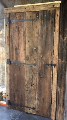 an old wooden door with metal handles