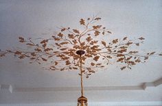 a chandelier hanging from the ceiling in a room with white walls and flooring