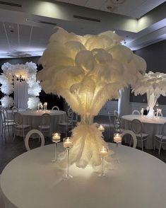 a white table topped with lots of candles